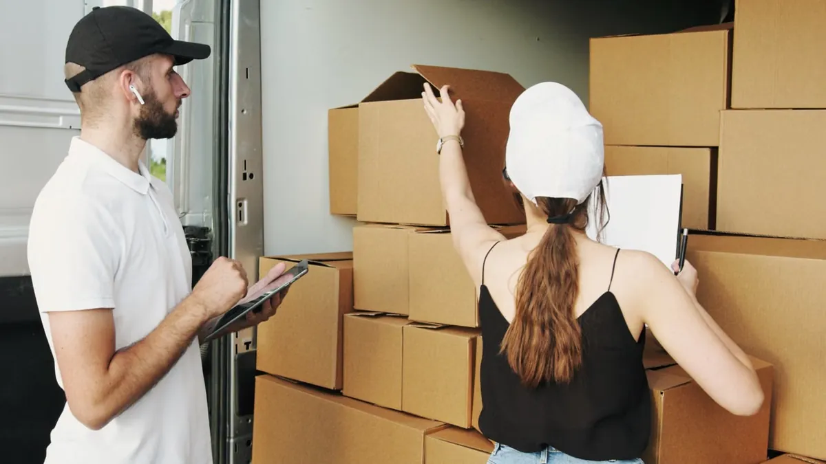 Couriers organizing parcels — illustrative stock photo